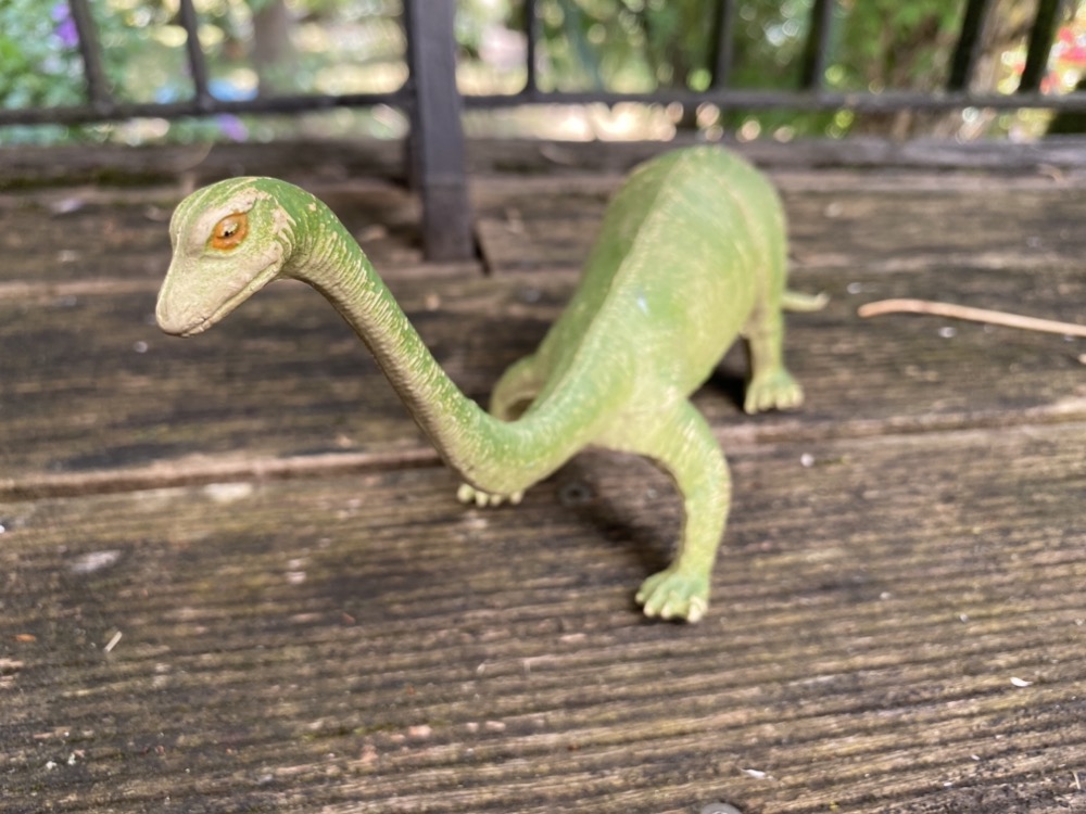 Grüner Spielzeug-Dinosaurier